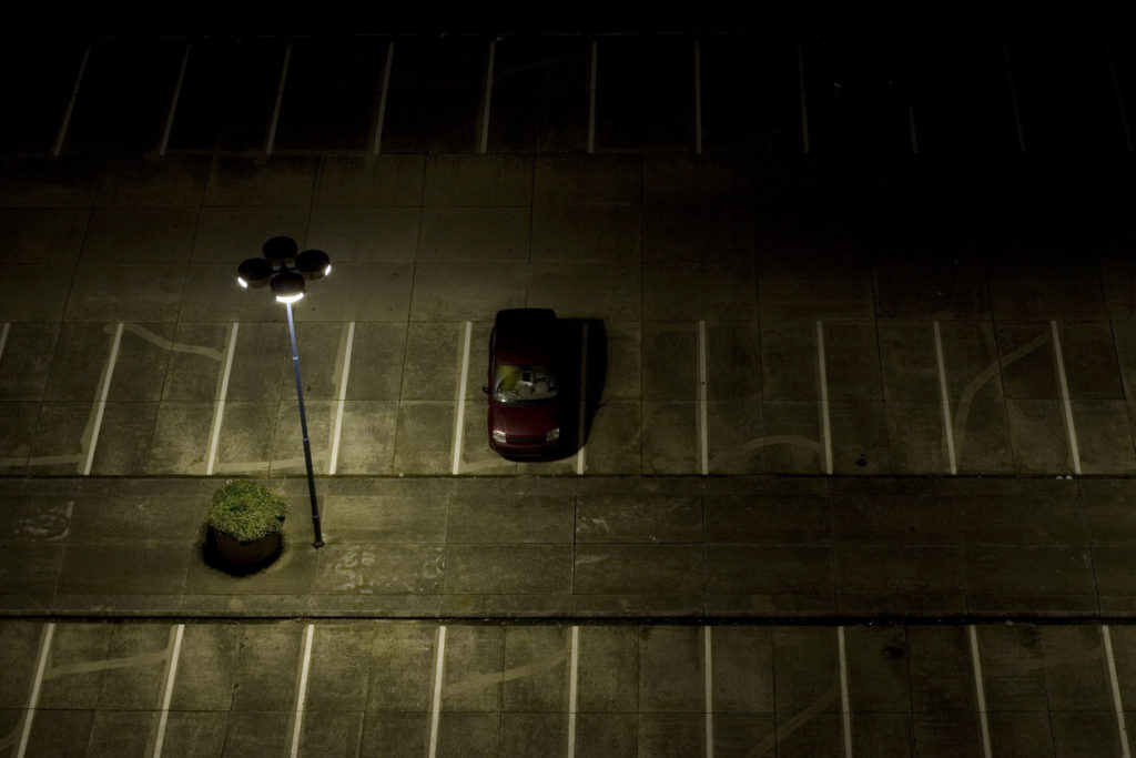 Car parked in a dimly lit lot.