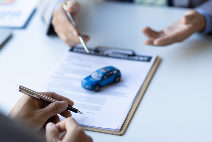 Signing auto insurance papers.